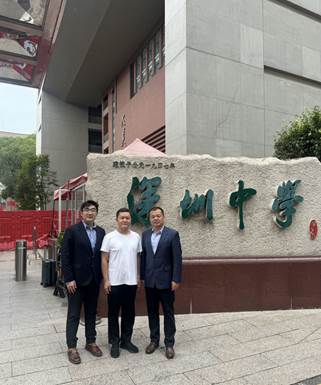 A group of men standing in front of a buildingDescription automatically generated